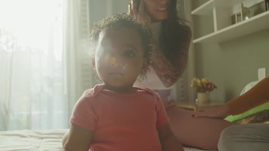A child is holding a crayon in bed