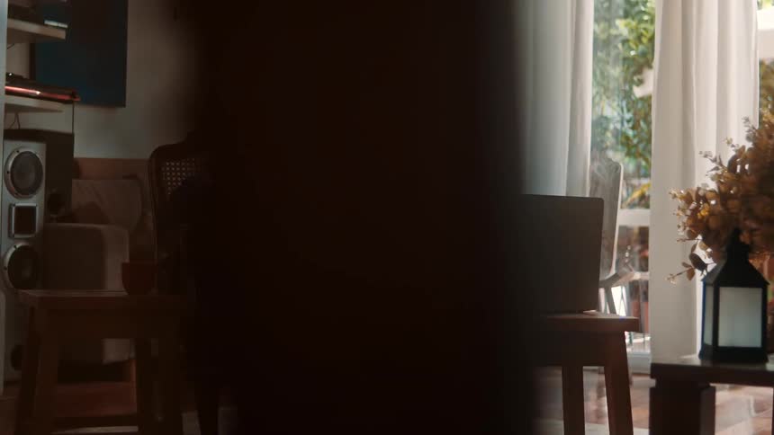 Pregnant woman smiling during a video call at home