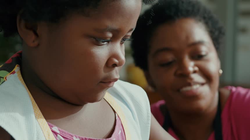 A mother is smiling and talking with her daughter