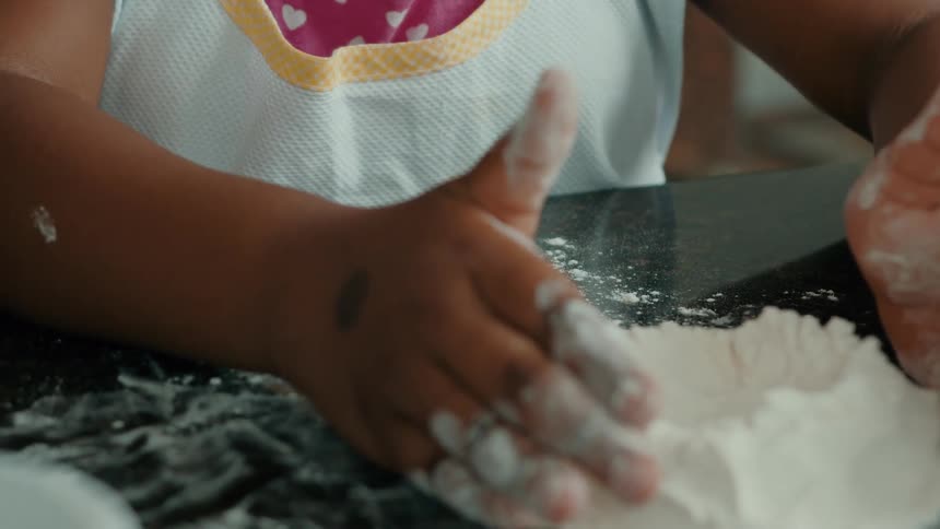 Little girl having fun with wheat flour