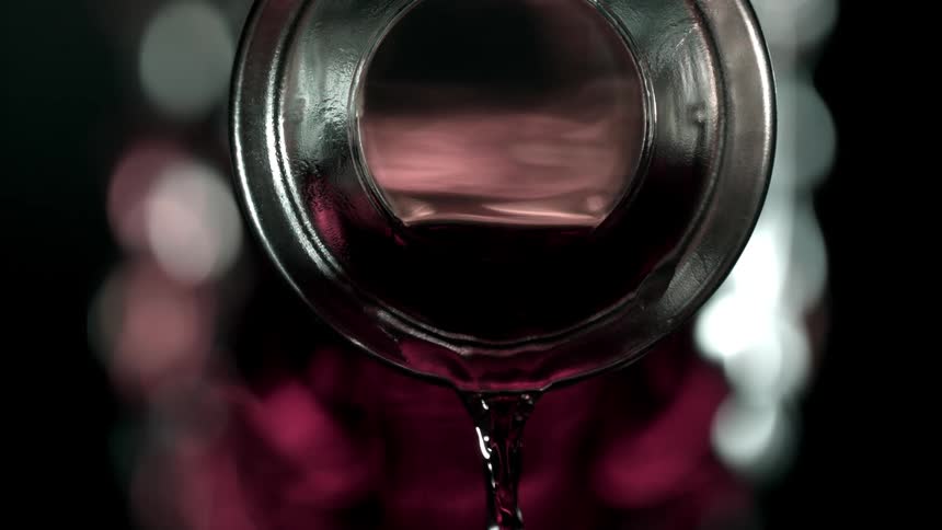 Pink liquid coming out of an abstract glass bottle