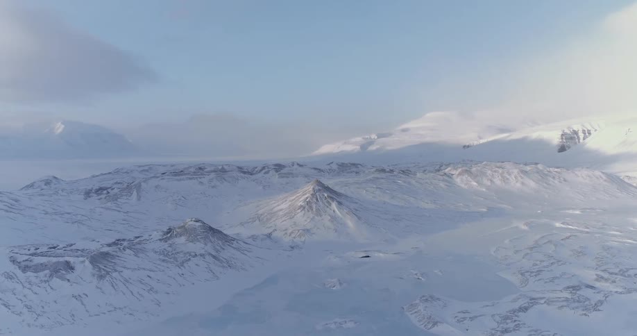 The mountain range below is covered with snow