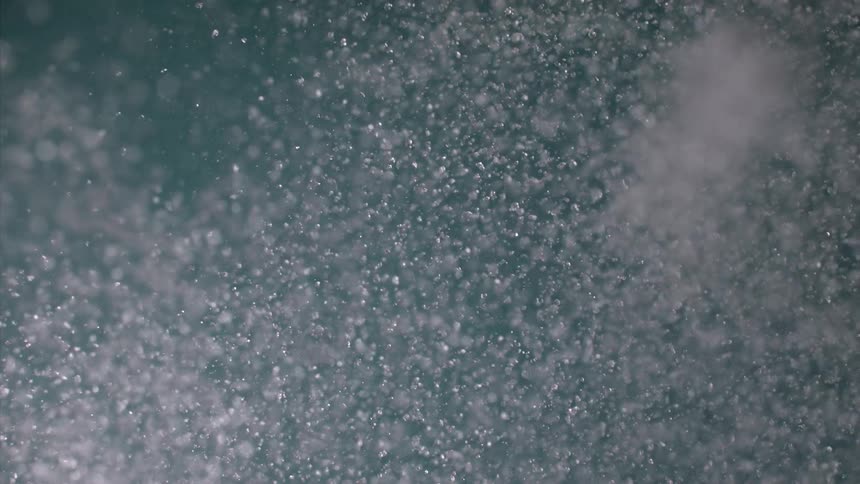 Whitish liquid falling abstractly