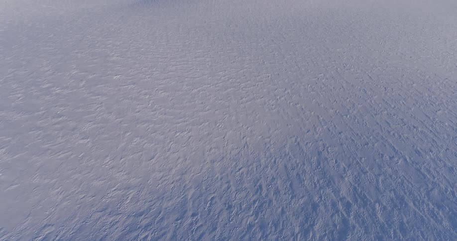 The long field is covered with snow below