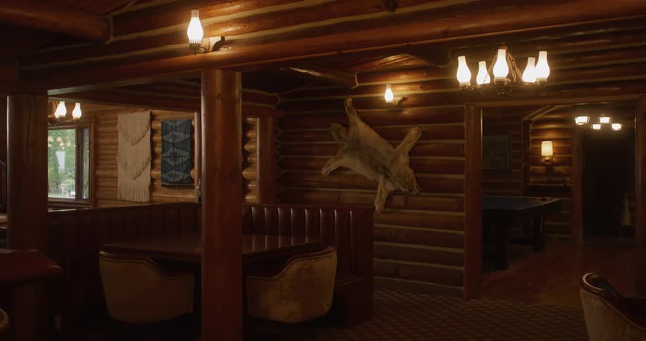 The log cabin has animal skins on the wall