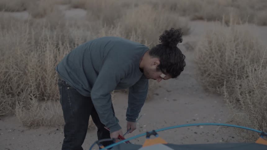 A person pitching a tent