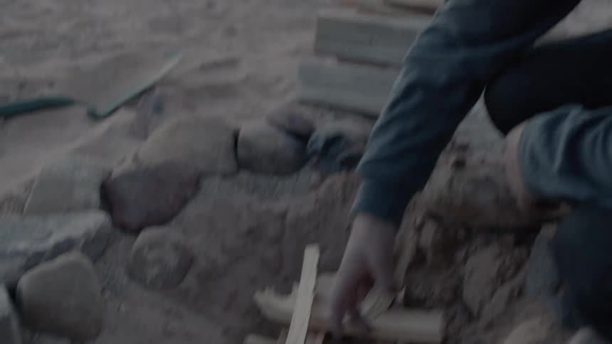 A person building a fire