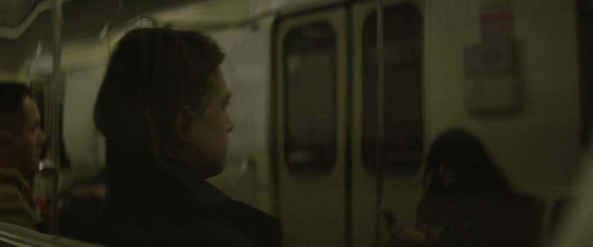 A man sitting on a subway