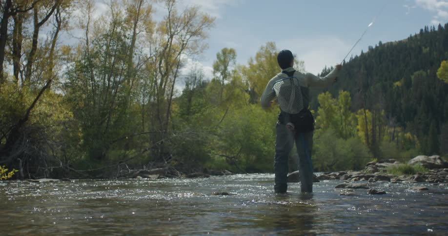 Man in a river fishing