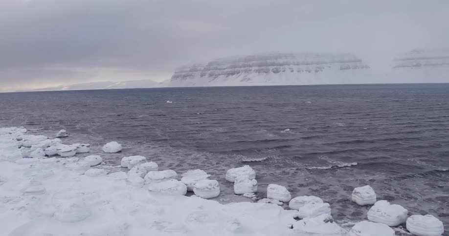 Ocean waves come to an icy shore