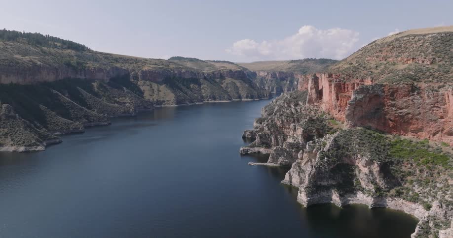 A river runs under cliffs