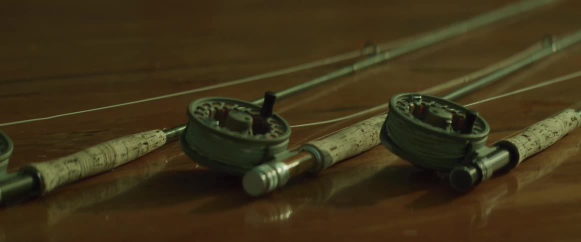 Three fishing rods on a table