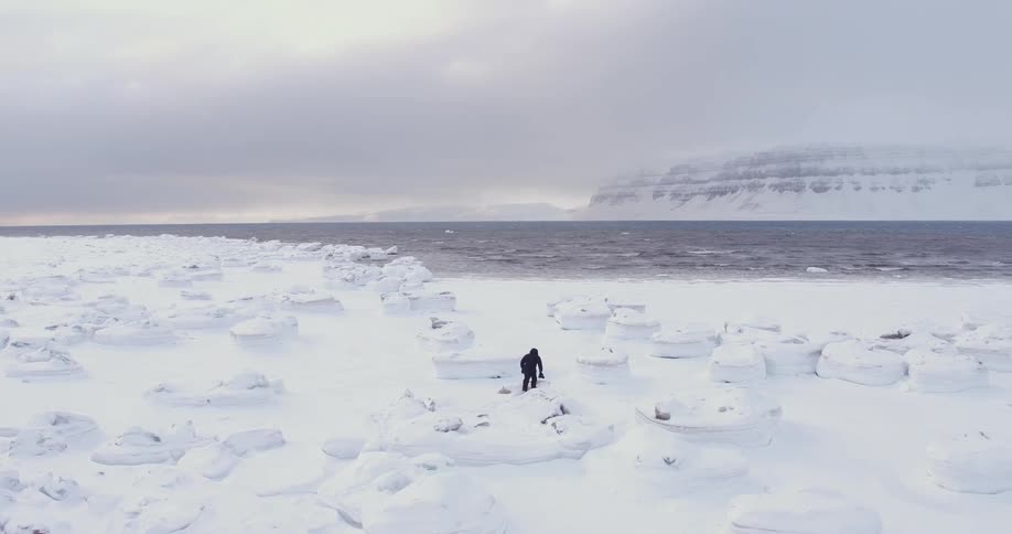 A photographer walks in the snowy wilderness
