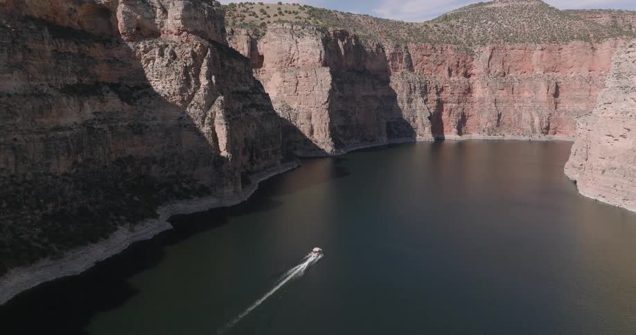 The boat is speeding through the river