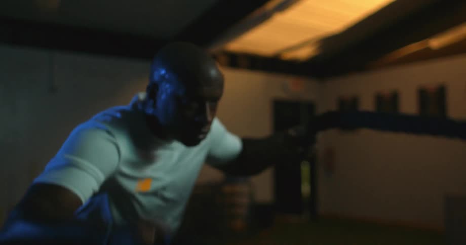 A man is exercising pulling ropes
