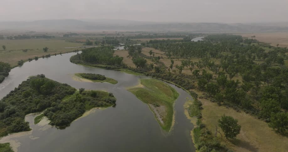 A lake sits in the middle of a field