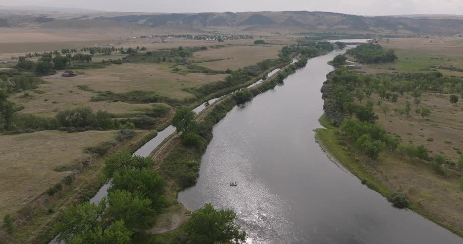 Landscape of a wide river with mountains on the horizon