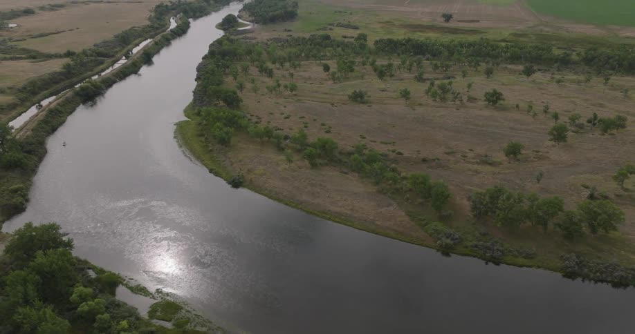 Curve of a river surrounded by green areas