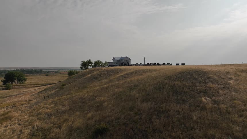 Multistory house sits on a hill in the rural countryside during the daytime