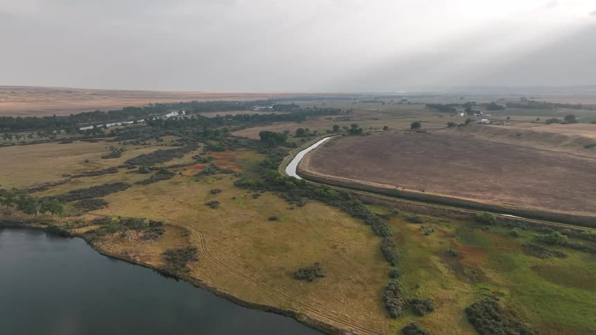 Rivers and canals wind through the rural countryside under an overcast sky