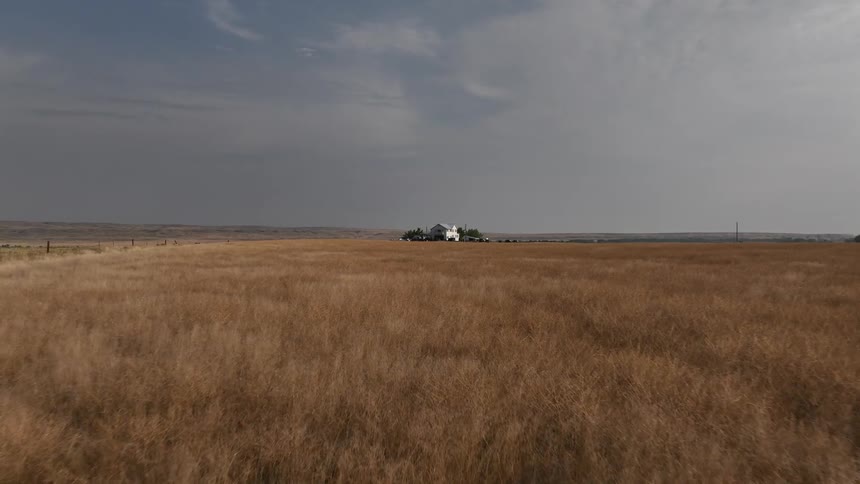 Isolated house in a natural field seen during a cloudy day