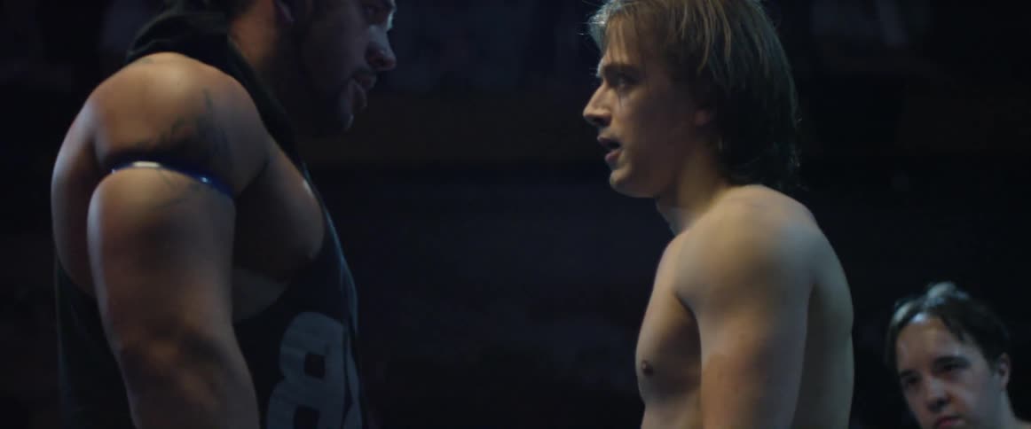 Two men are facing off in a dark ring