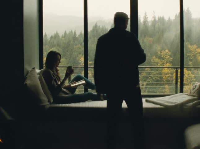 A man hands coffee to a woman