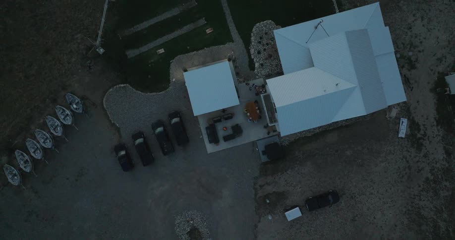 A rural home has many boats on the property