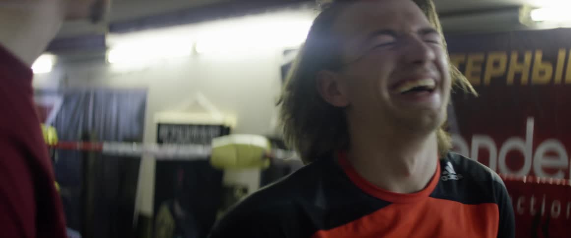 Two men talk laughing together
