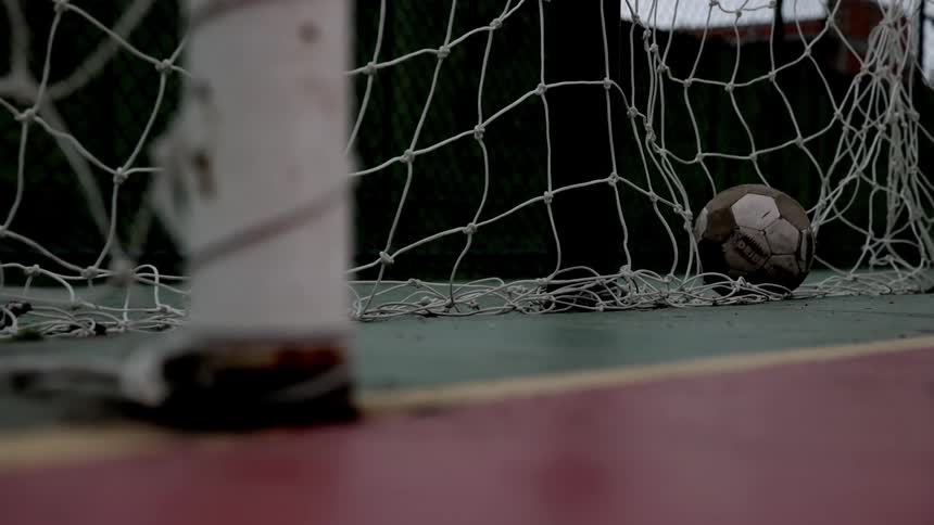Soccer ball stopped inside a goal with a net