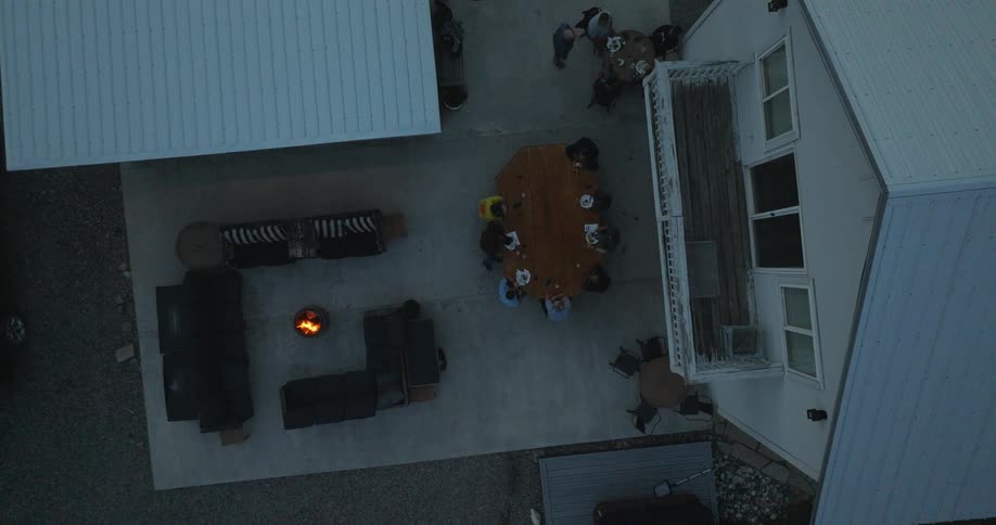 Overhead view of people having a get together outdoors on the patio at night