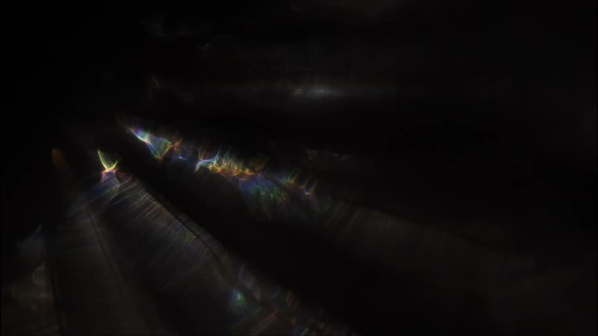 Patterned reflections of light on a dark background