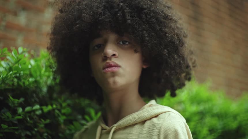 A teenager has long puffy hair