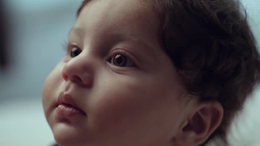 Close up of a babys face looking up