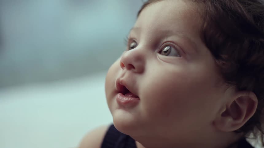 A happy baby is looking up