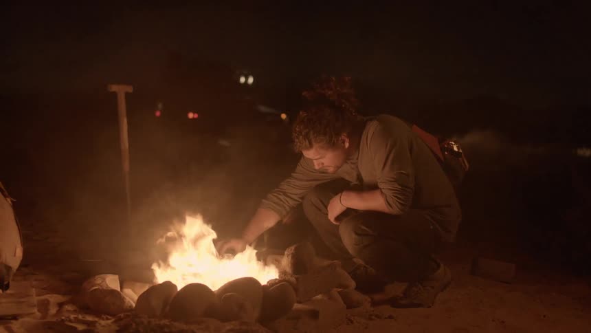 A person sitting by a campfire