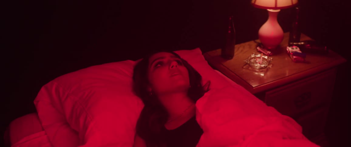 The sad girl in bed puts the covers over her face
