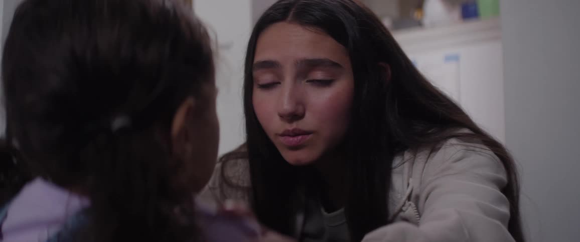 A teenager is consoling her sister and talking