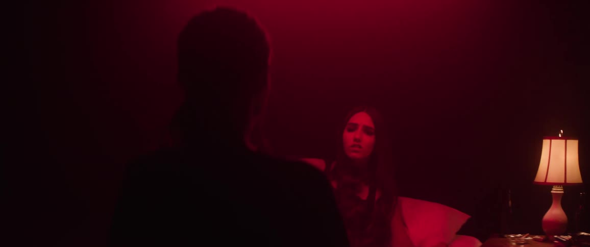 A girl wakes up to see a woman watching her