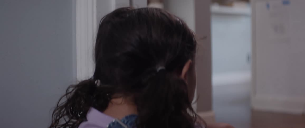 A teenage girl comforts her little sister and then grabs the hand of someone and leaves