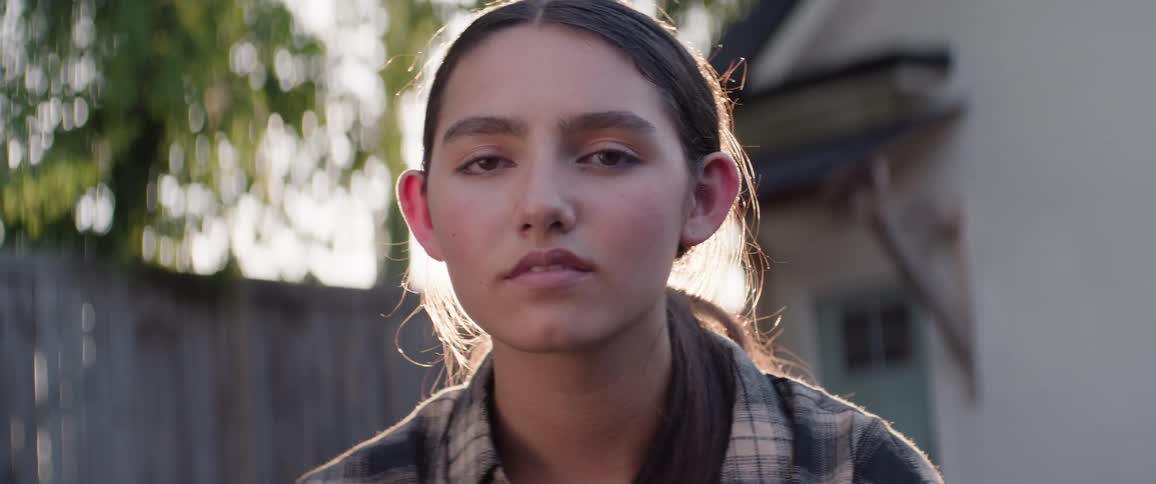 The girl opens her eyes in the yard