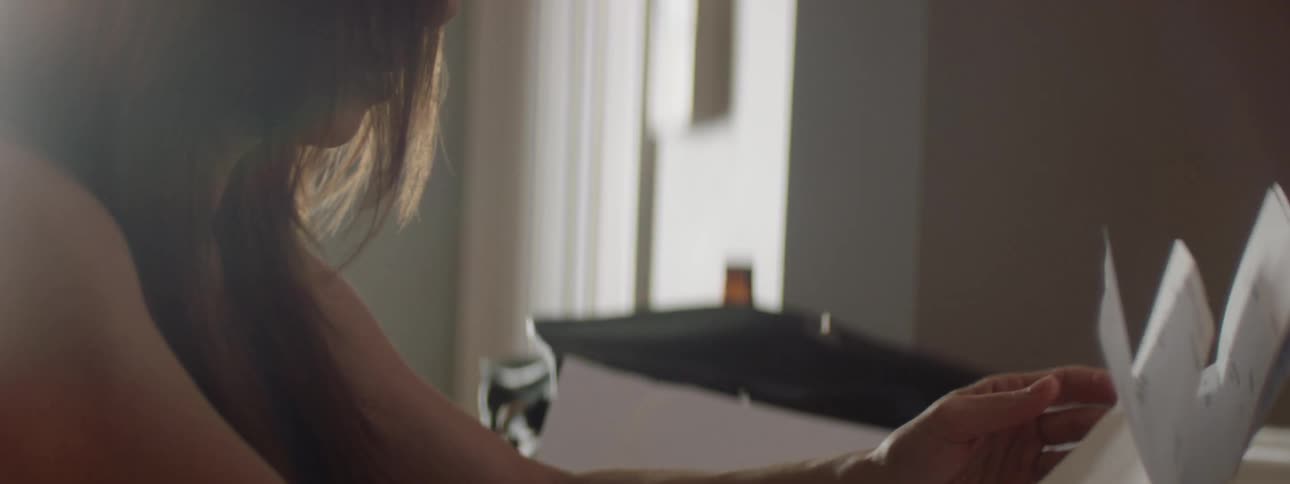 Woman worries while looking through bills