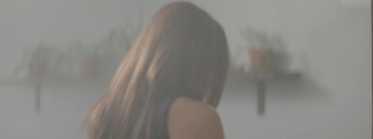 A woman deep in thought is pacing around an empty room