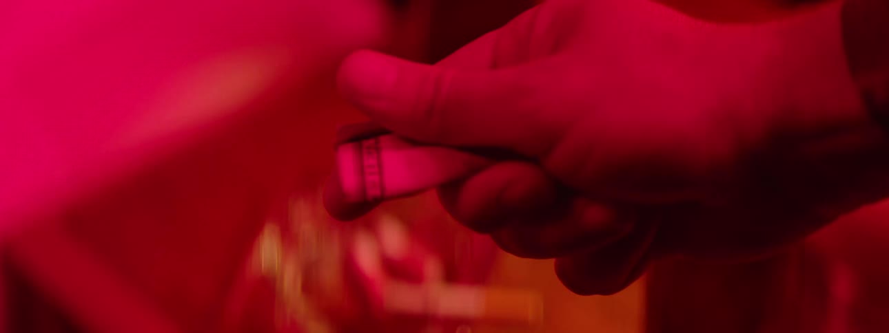 Two people exchange money during a fingertip handshake