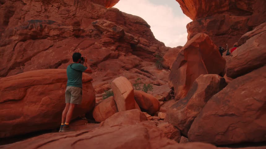 A man is taking pictures of the canyon