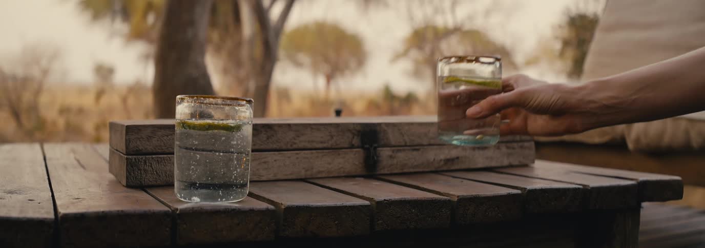 Hand picking up a glass of drink