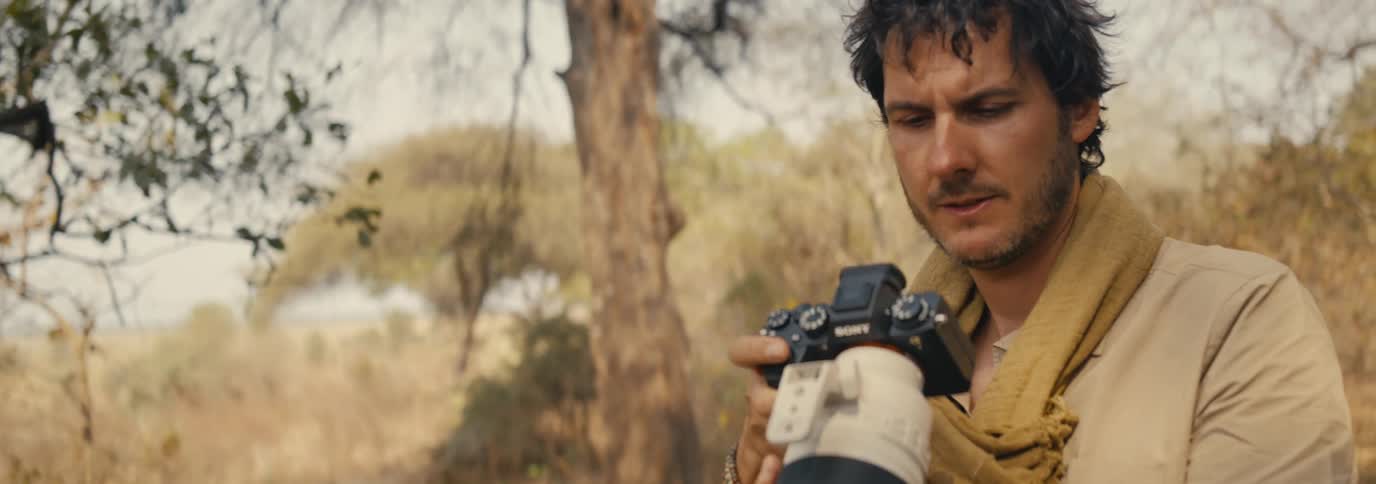 Photographer with professional camera in a jungle