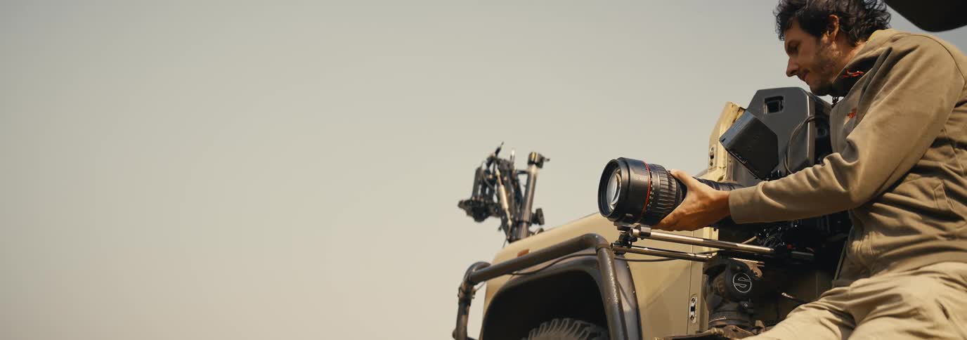 Man has a transport holding a professional filming device outdoors