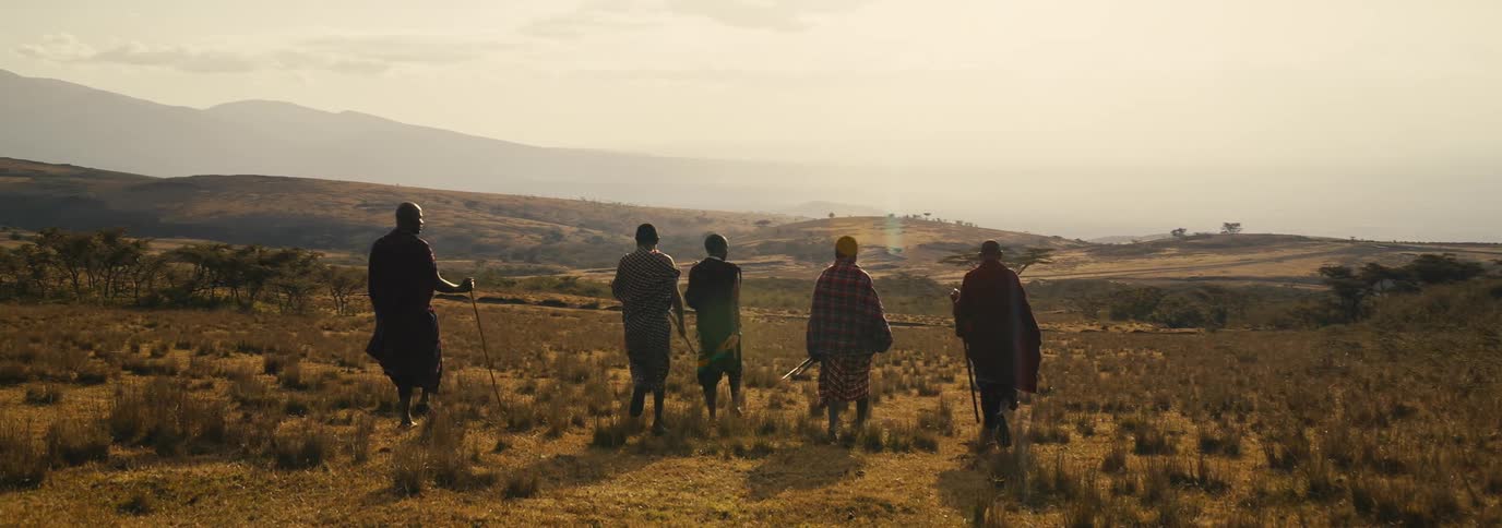 Group of people from a tribe walking in an outdoor environment