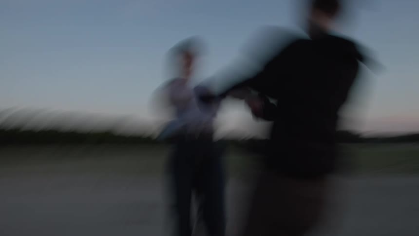 Two women hold hands and swing in a circle